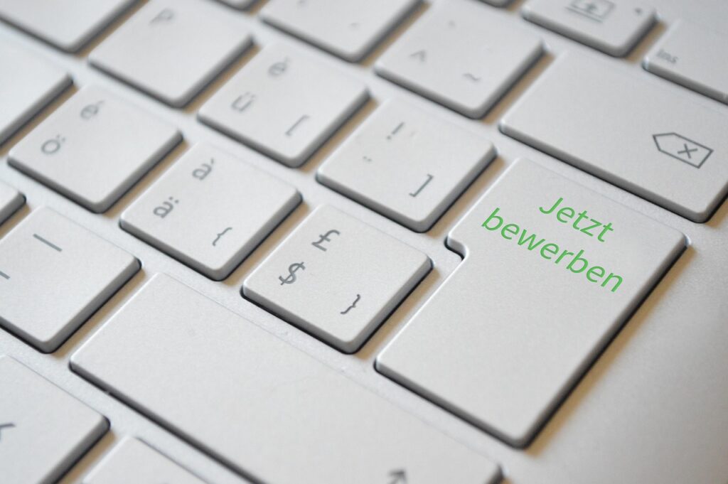 A person looking at a laptop with job search websites open, illustrating the job hunting process.