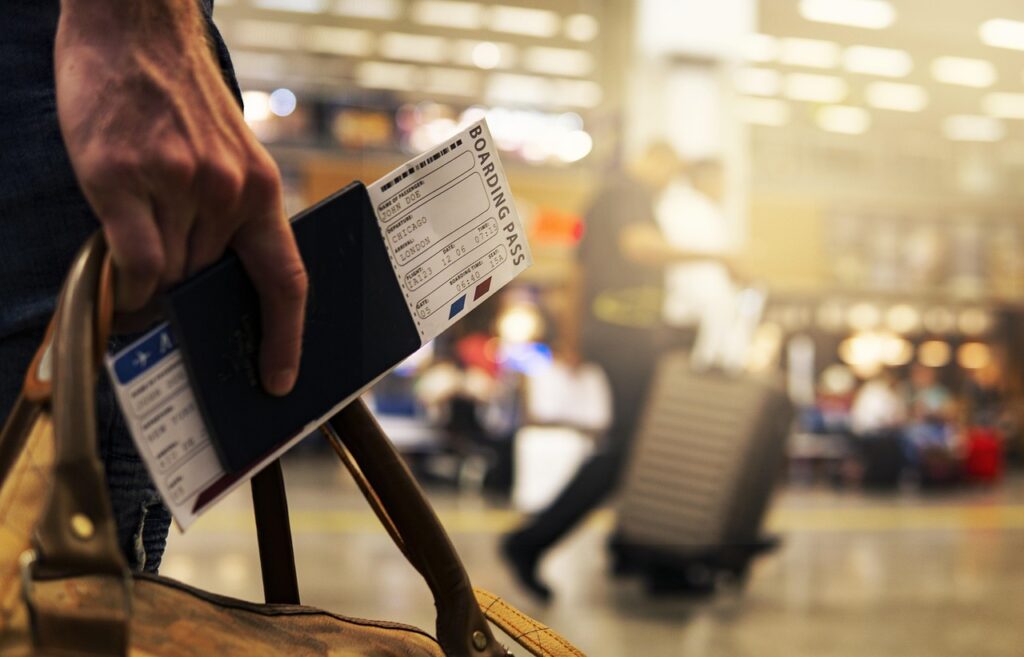 A young Sri Lankan student with a passport and luggage, ready to travel abroad for their studies.